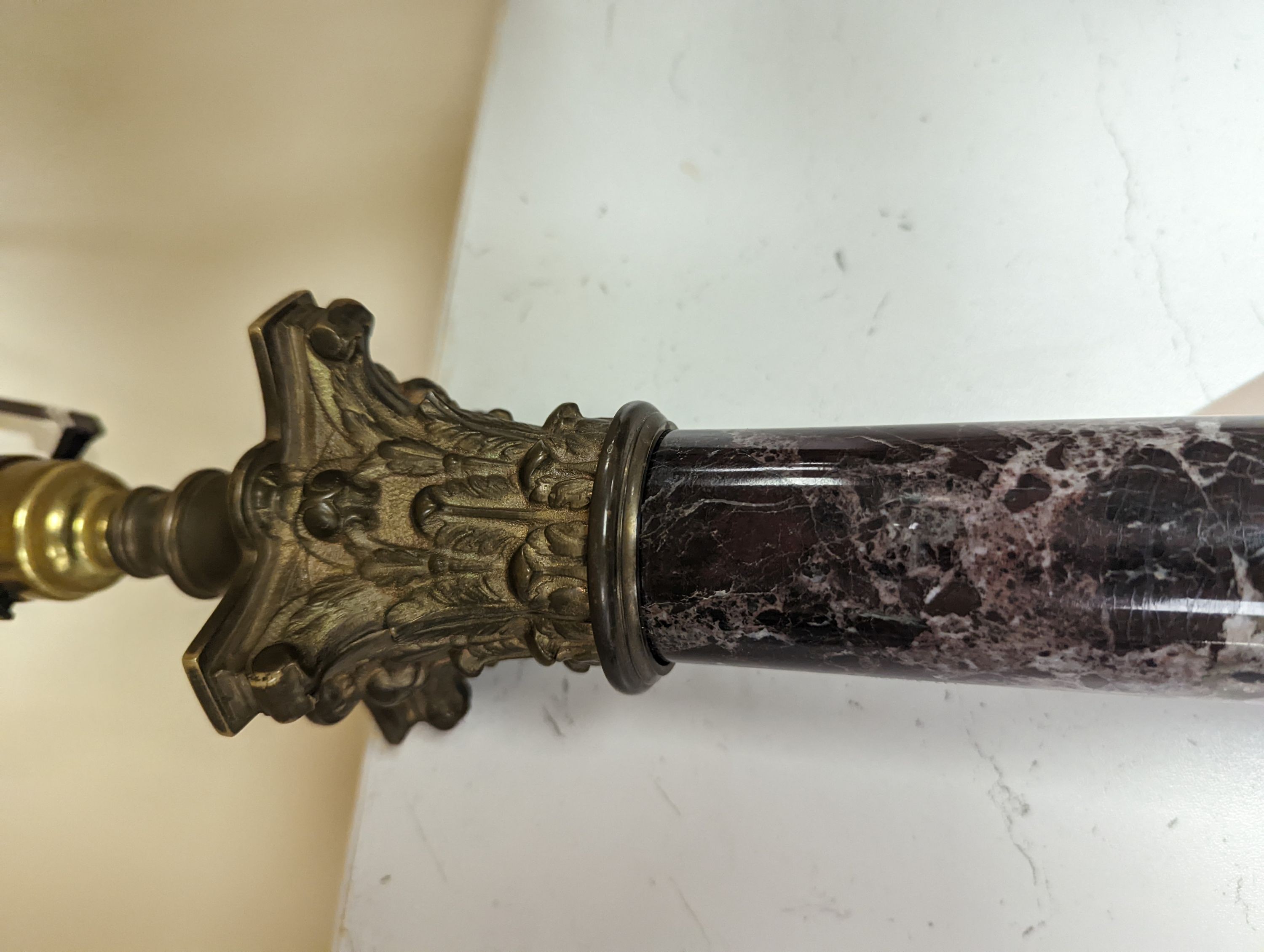 A brass and variegated marble Corinthian column lamp base, 47cms high, not including light fitting.